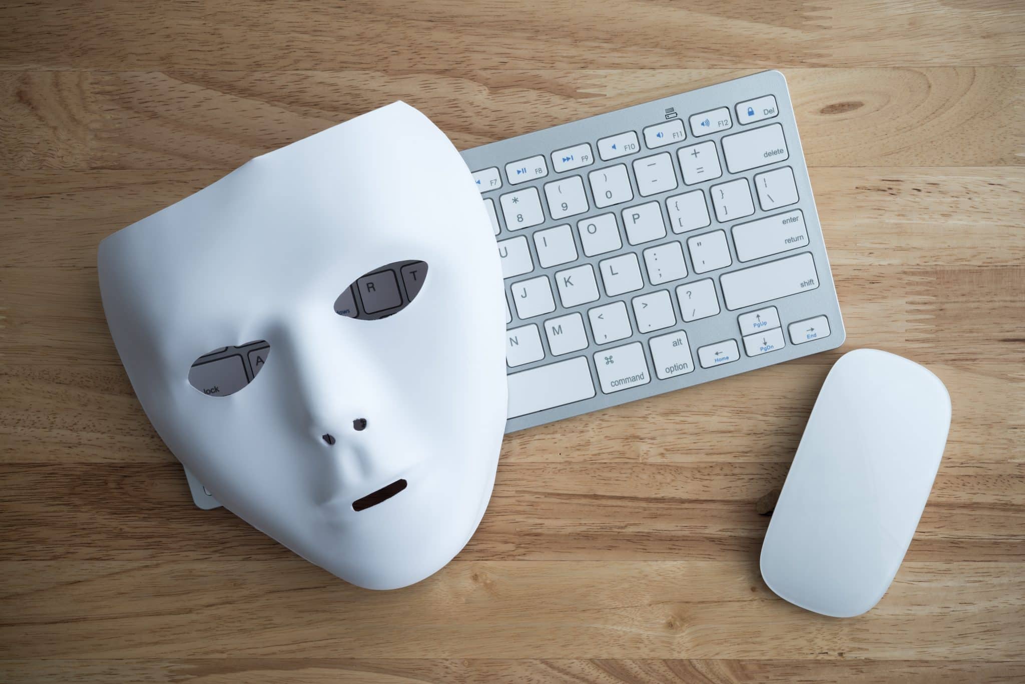 white mask, mouse, and keyboard on wooden table