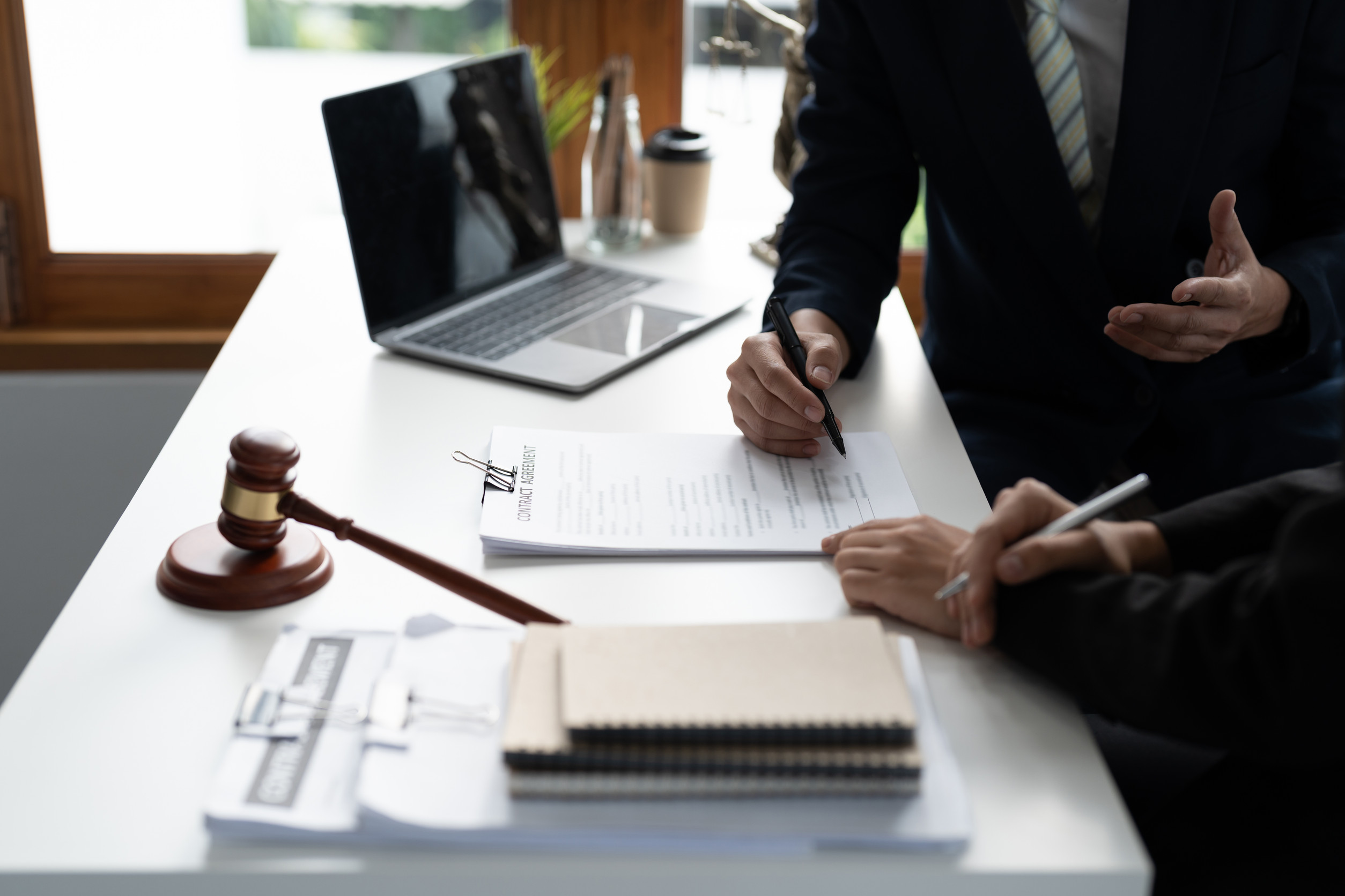 A lawyer reviewing deposition documents and public records during a court proceeding.